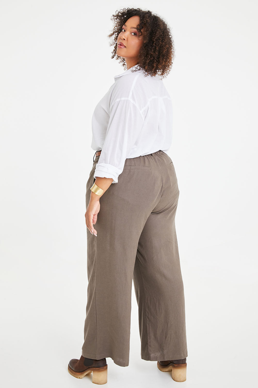 Model Alexis wearing size 16 of the Can Do It All Pants in colour Concrete (Grey), from the back