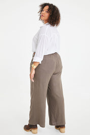 Model Alexis wearing size 16 of the Can Do It All Pants in colour Concrete (Grey), from the back