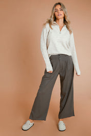 Model Alice wearing size 10 of the Can Do It All Pants in colour Concrete (Grey), from the front, showing the whole outfit