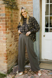 Model Tegan wearing size 10 of the Can Do It All Pants in colour Concrete (Grey), from the front, showing the whole outfit