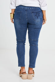 Model Laura wearing size 14 of the Wild Plains Flat Front Stitch Jeggings in colour Darkdenim (Blue), from the back