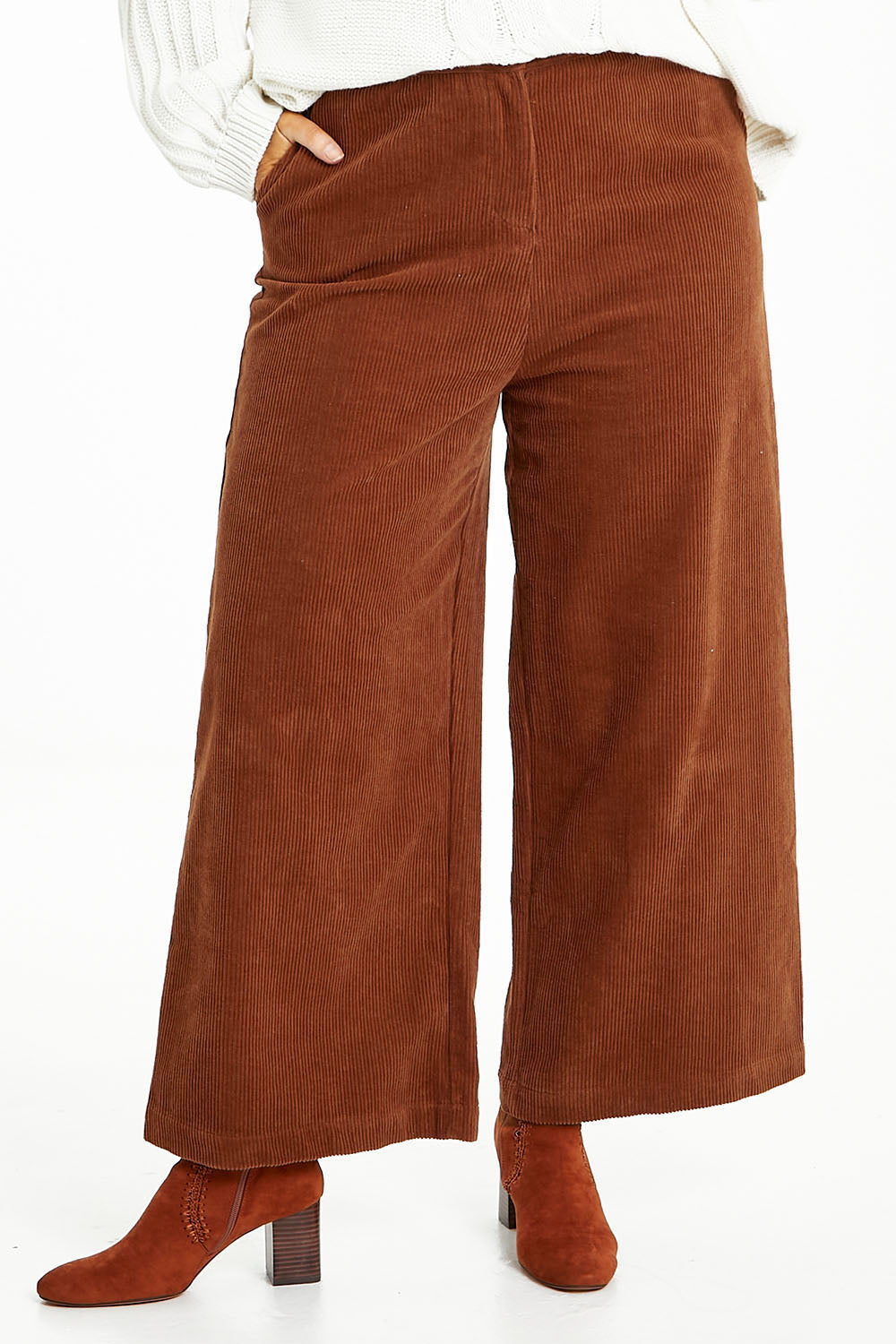 Model Laura wearing size 14 of the Feeling Good Wide Leg Cord Pants in colour Rust, from the front, cropped image