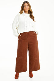 Model Laura wearing size 14 of the Feeling Good Wide Leg Cord Pants in colour Rust, from the front, showing the whole outfit