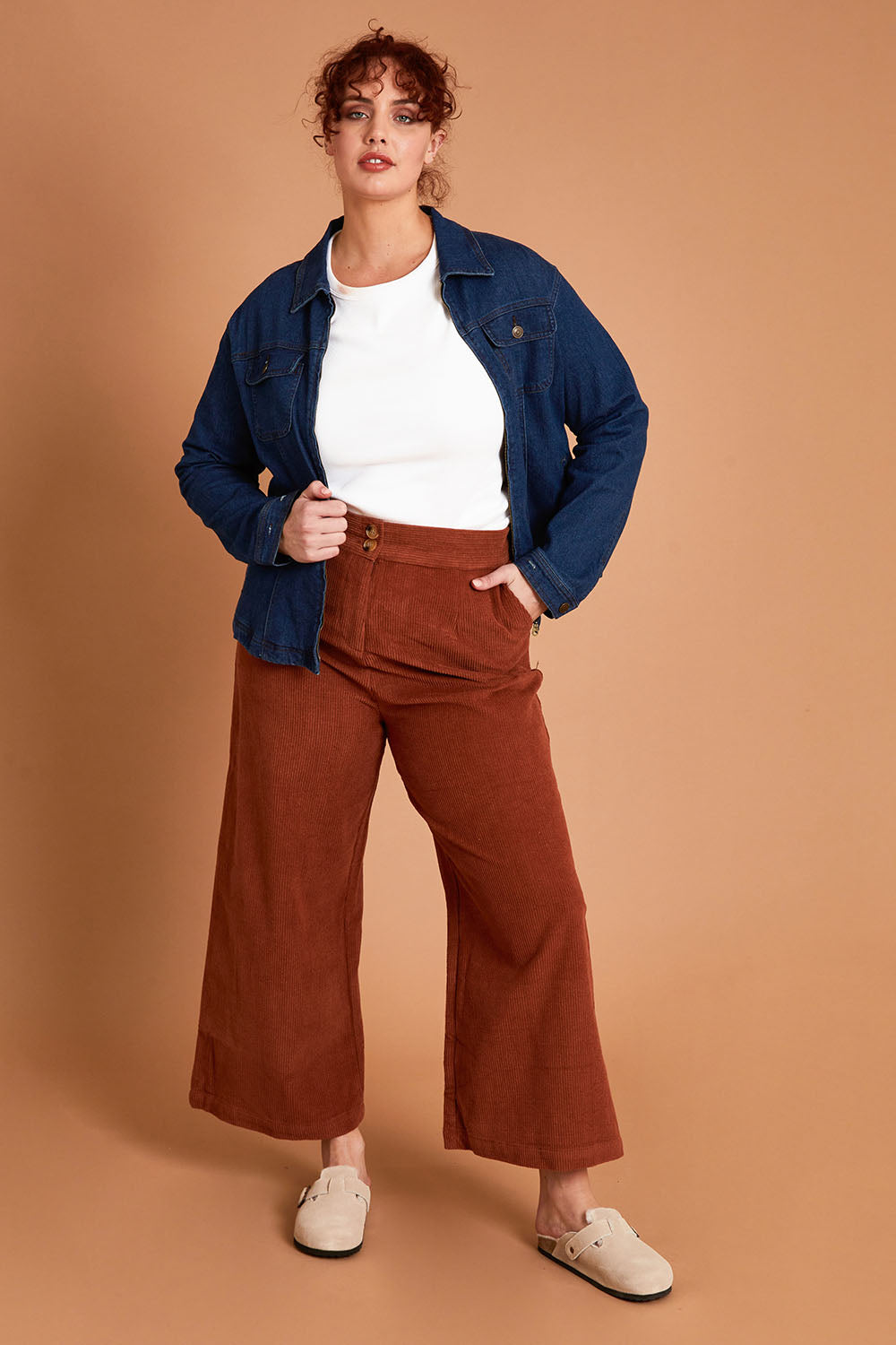 Model Maddy wearing size 16 of the Feeling Good Wide Leg Cord Pants in colour Rust, from the front, showing the whole outfit