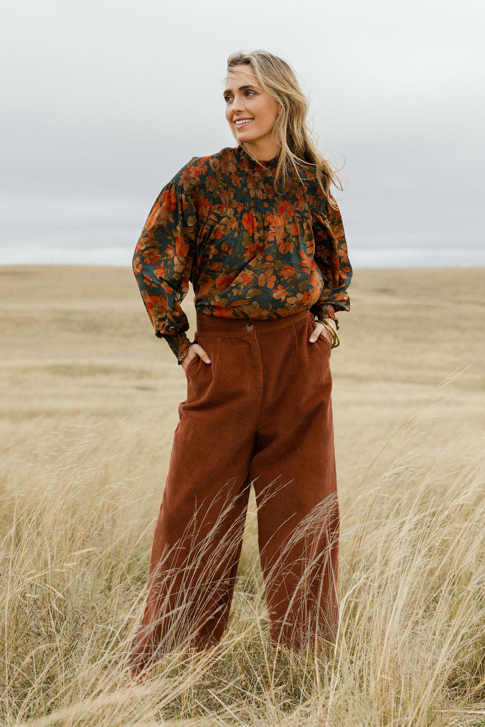 Model Tegan wearing size 10 of the Feeling Good Wide Leg Cord Pants in colour Rust, from the front, showing the whole outfit