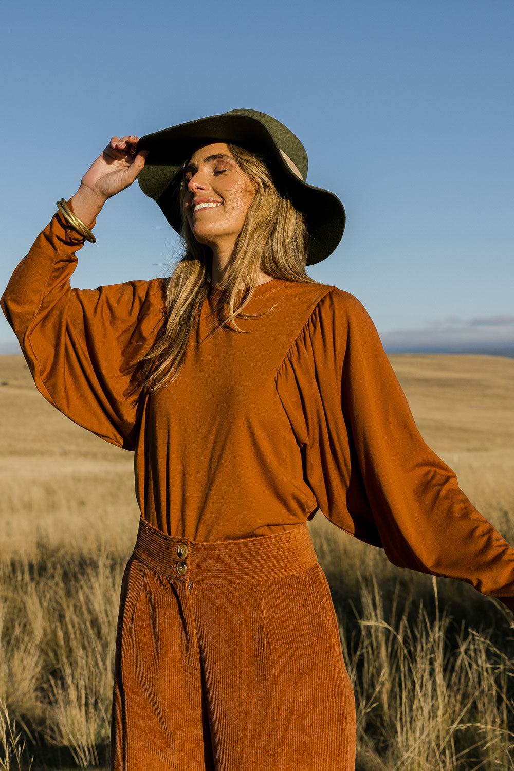 Model Tegan wearing size 10 of the Ive Got This Top in colour Toffee, from the front, showing the whole outfit