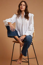 Model Madeline wearing size 10 of the Ruffled Feathers Blouse in colour White (White), from the front, showing the whole outfit