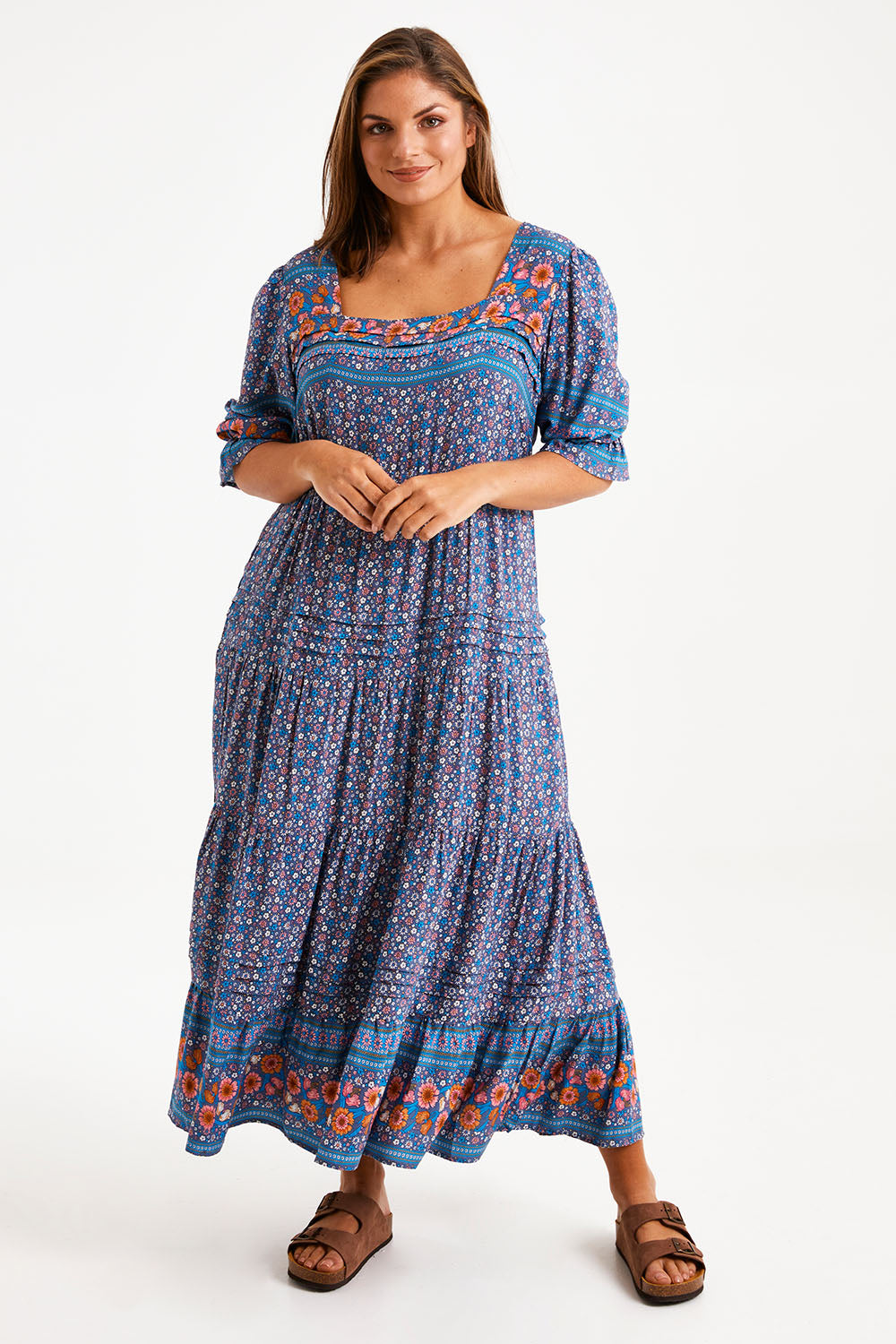 Model Monique wearing size 14 of the Paradise Found Maxi Dress in colour Denimfleur (Blue), from the front, showing the whole outfit