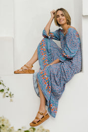 Model Tegan wearing size 10 of the Paradise Found Maxi Dress in colour Denimfleur (Blue), from the front, showing the whole outfit