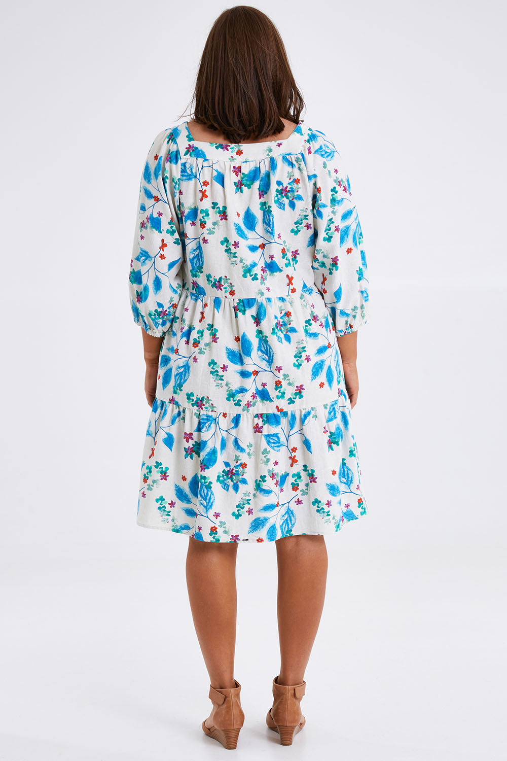 Model Monique wearing size 14 of the Chasing Blue Sky Cotton Dress in colour Blueleaf (Blue), from the back