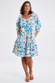 Model Monique wearing size 14 of the Chasing Blue Sky Cotton Dress in colour Blueleaf (Blue), from the front, showing the whole outfit