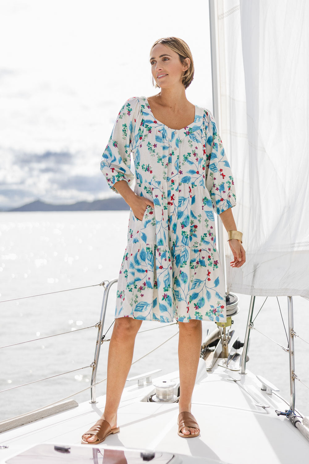 Model Tegan wearing size 10 of the Chasing Blue Sky Cotton Dress in colour Blueleaf (Blue), from the front, showing the whole outfit