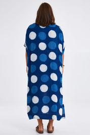 Model Monique wearing size 14 of the Beautiful Travels Dress in colour Indigo (Blue), from the back