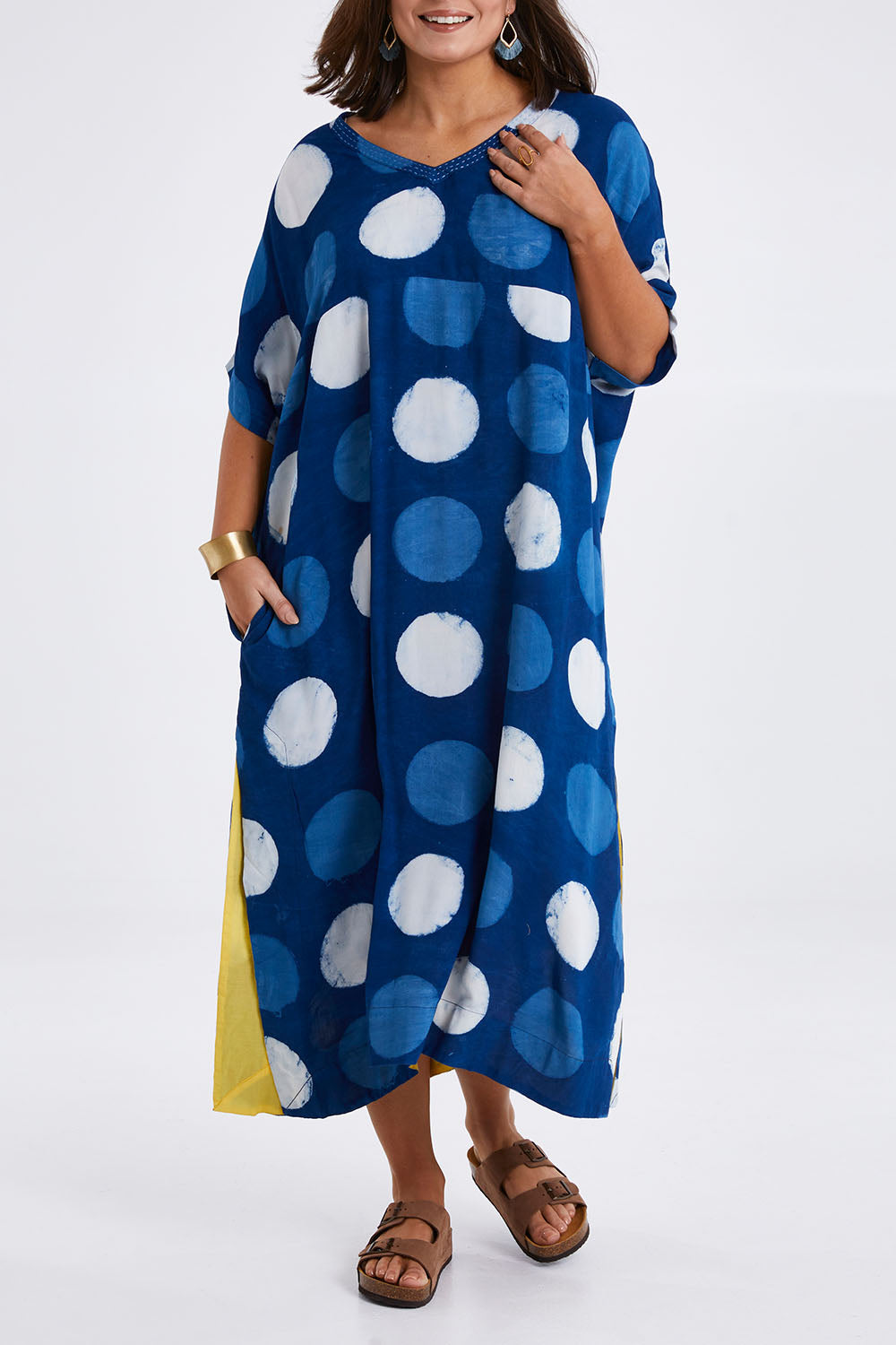 Model Monique wearing size 14 of the Beautiful Travels Dress in colour Indigo (Blue), from the front, cropped image
