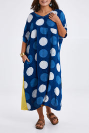 Model Monique wearing size 14 of the Beautiful Travels Dress in colour Indigo (Blue), from the front, cropped image