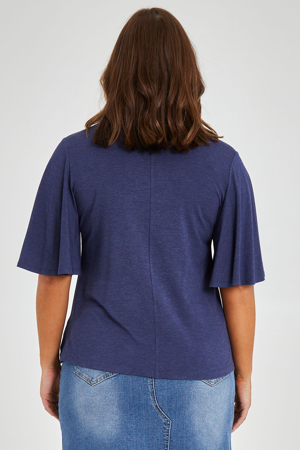 Model Monique wearing size 14 of the Flutter By Tee in colour Marldenim (Blue), from the back