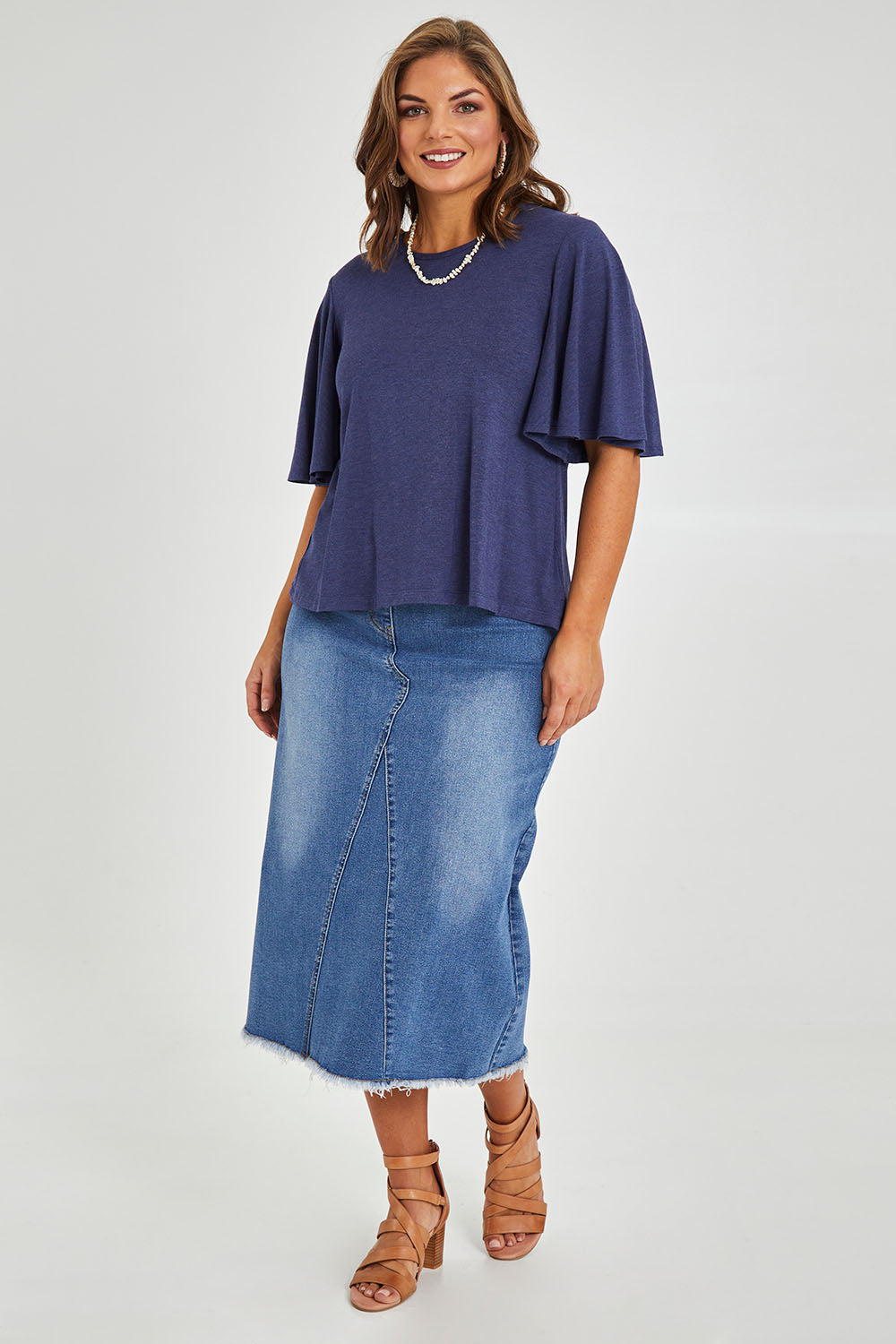 Model Monique wearing size 14 of the Flutter By Tee in colour Marldenim (Blue), from the front, showing the whole outfit