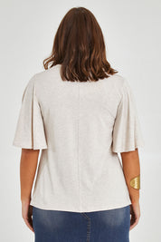 Model Monique wearing size 14 of the Flutter By Tee in colour Natural, from the back