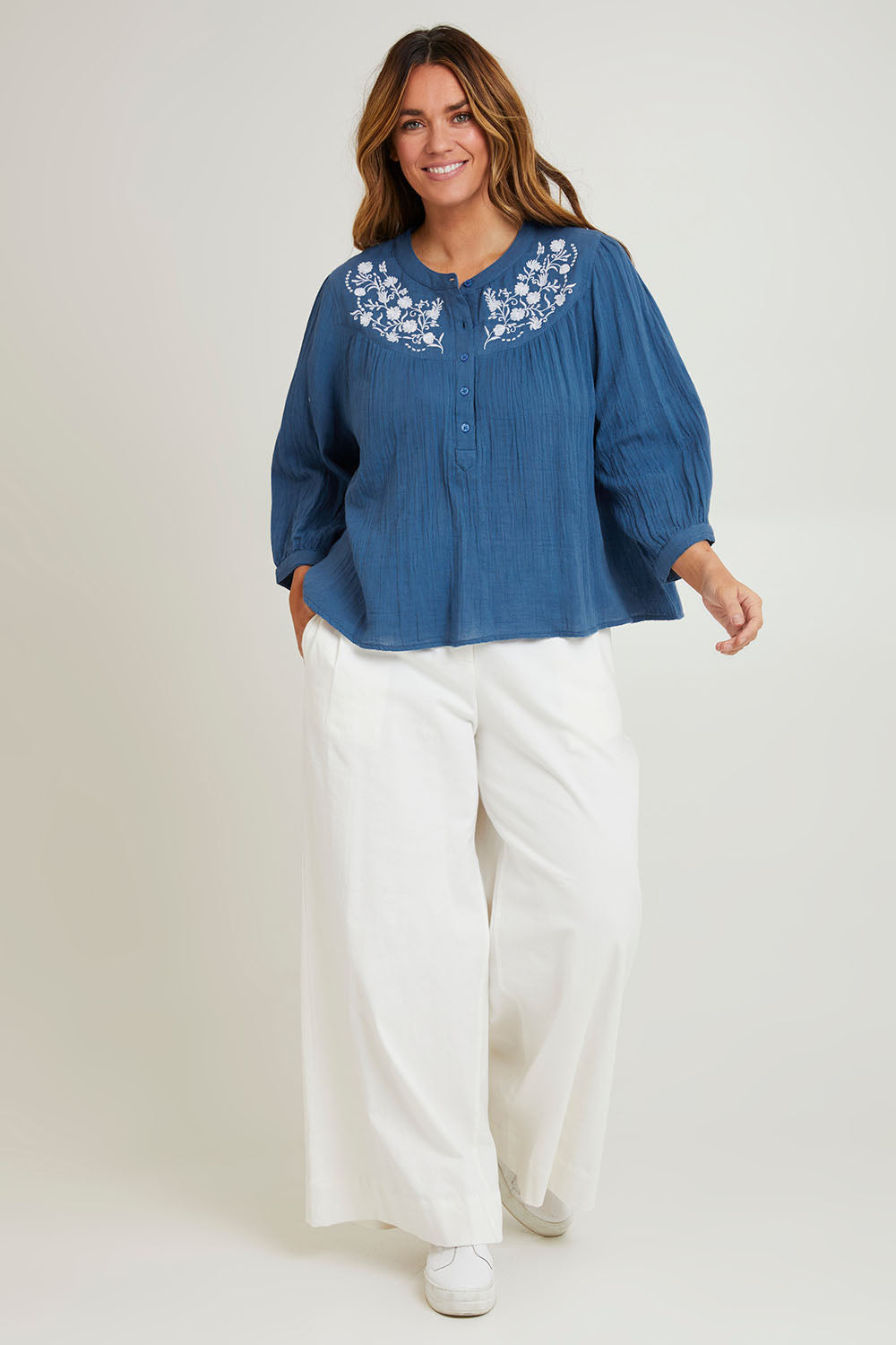 Model Laura wearing size 14 of the First Light Cotton Blouse in colour Dutchblue (Blue), from the front, showing the whole outfit