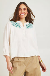Model Jane wearing size 14 of the First Light Cotton Blouse in colour Milk (White), from the front, cropped image