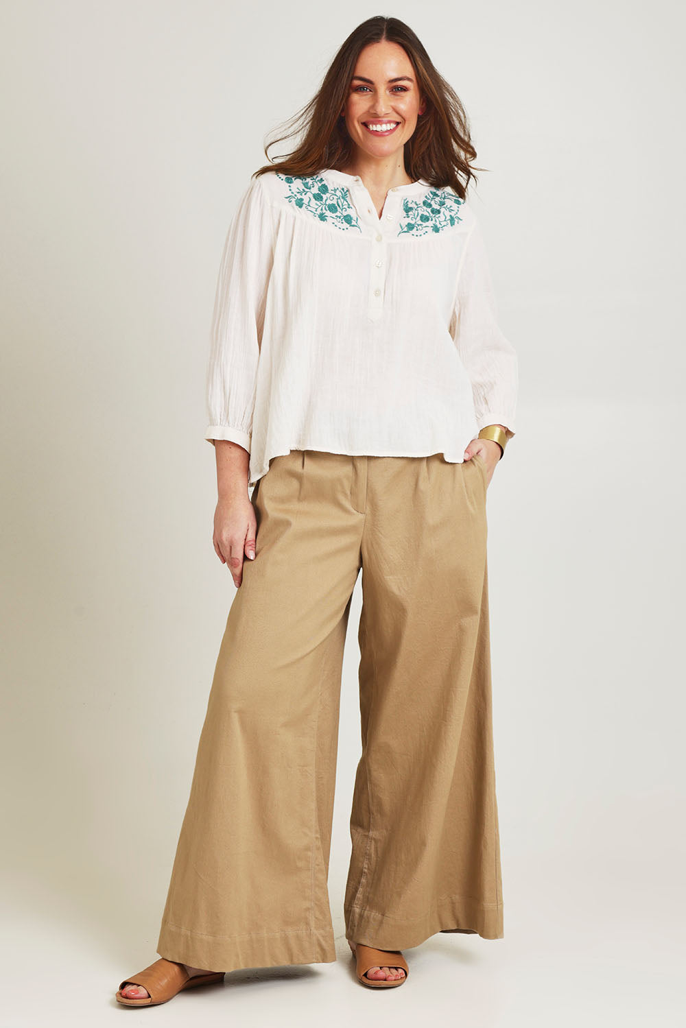 Model Jane wearing size 14 of the First Light Cotton Blouse in colour Milk (White), from the front, showing the whole outfit