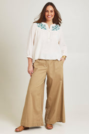 Model Jane wearing size 14 of the First Light Cotton Blouse in colour Milk (White), from the front, showing the whole outfit