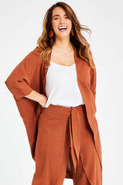 Model Laura wearing size 14 of the Falling For You Cotton Cardi in colour Cinnamon, from the front, cropped image