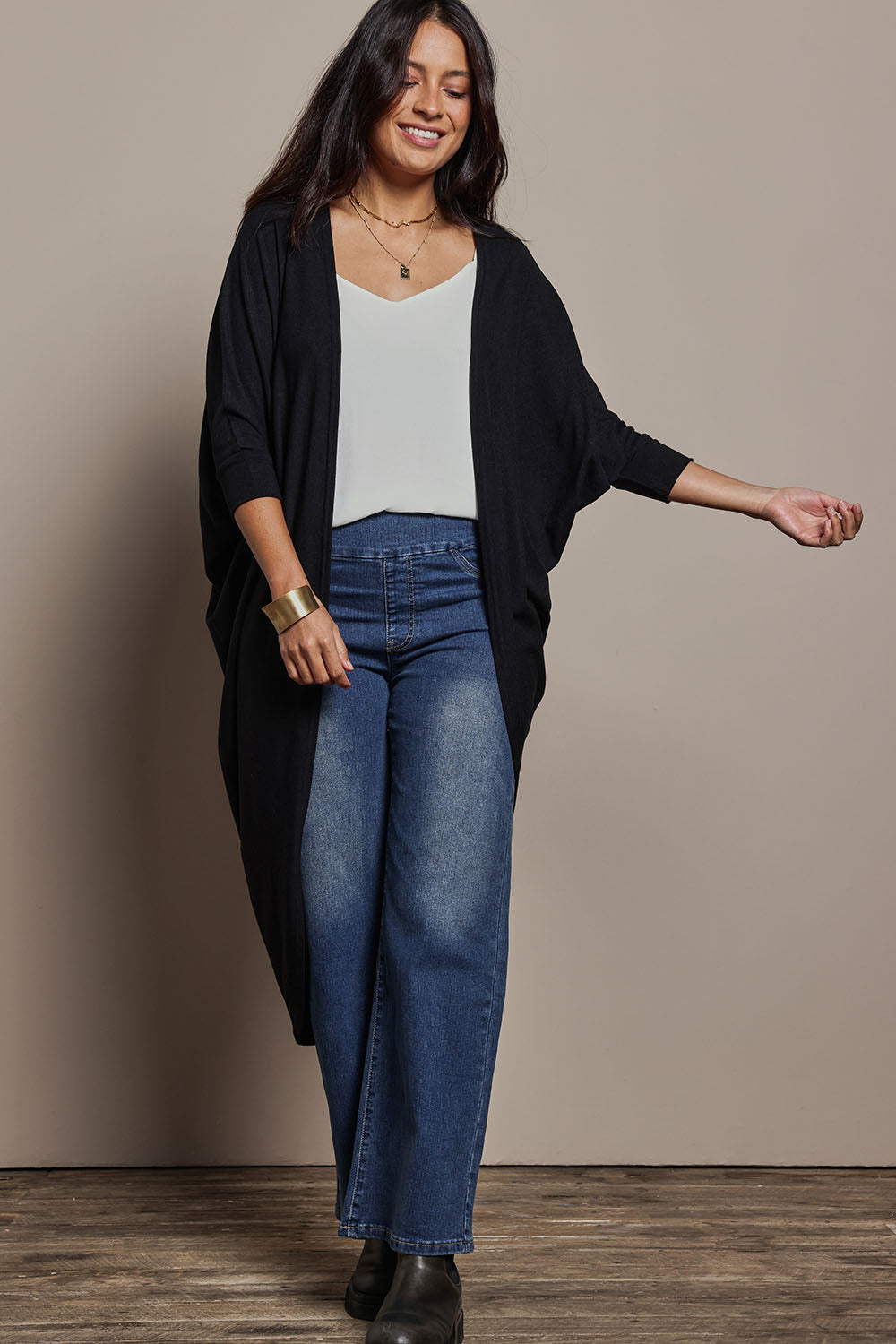 Model Tahnee wearing size 10 of the Falling For You Cardi in colour Black (Black), from the front, showing the whole outfit