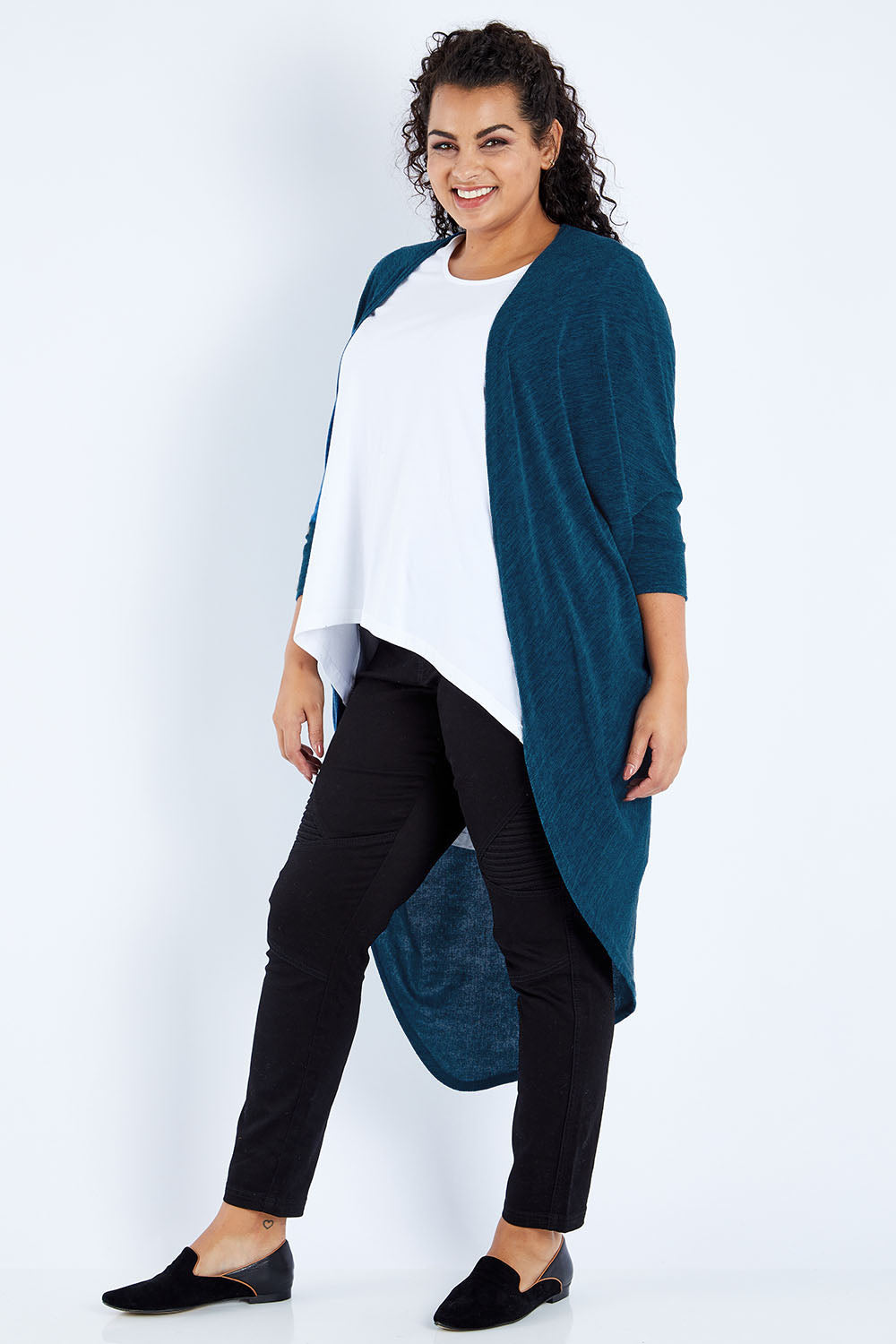 Model Sasha-Lee wearing size 16 of the Falling For You Cardi in colour Petrol (Blue), from the front, showing the whole outfit