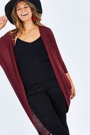 Model Palatina wearing size 14 of the Falling For You Cardi in colour Port (Purple), from the front, cropped image