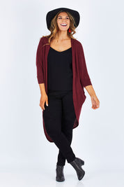 Model Palatina wearing size 14 of the Falling For You Cardi in colour Port (Purple), from the front, showing the whole outfit