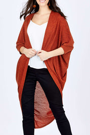 Model Georgia wearing size 10 of the Falling For You Cardi in colour Rust, from the front, cropped image