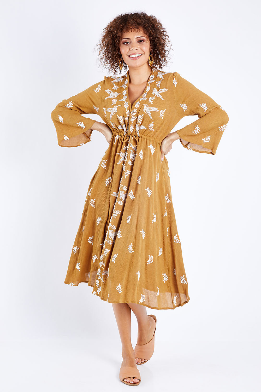 Model Lala wearing size 10 of the Dancing With Birds Midi Dress in colour Clay, from the front, showing the whole outfit