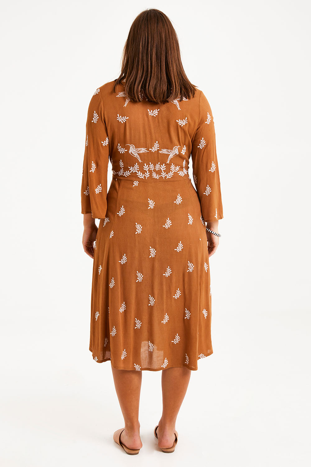 Model Monique wearing size 14 of the Dancing With Birds Midi Dress in colour Clay, from the back
