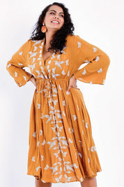Model Sasha-Lee wearing size 16 of the Dancing With Birds Midi Dress in colour Clay, from the front, cropped image