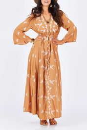 Model Gemma wearing size 10 of the Dancing With Birds Dress in colour Golden, from the front, cropped image