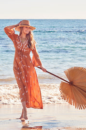 Model Marnee wearing size 10 of the Dancing With Birds Dress in colour Golden, from the front, showing the whole outfit
