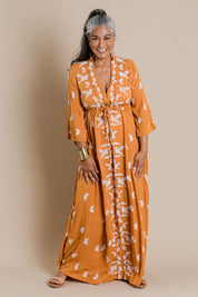 Model Nadine wearing size 10 of the Dancing With Birds Dress in colour Golden, from the front, showing the whole outfit