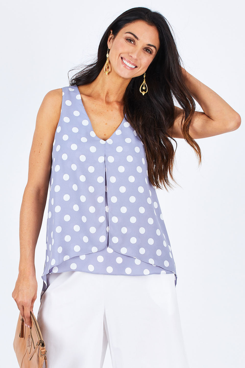 Model Gemma wearing size 10 of the Sugar Snaps Layer Tank in colour Dustyblue (Blue), from the front, cropped image