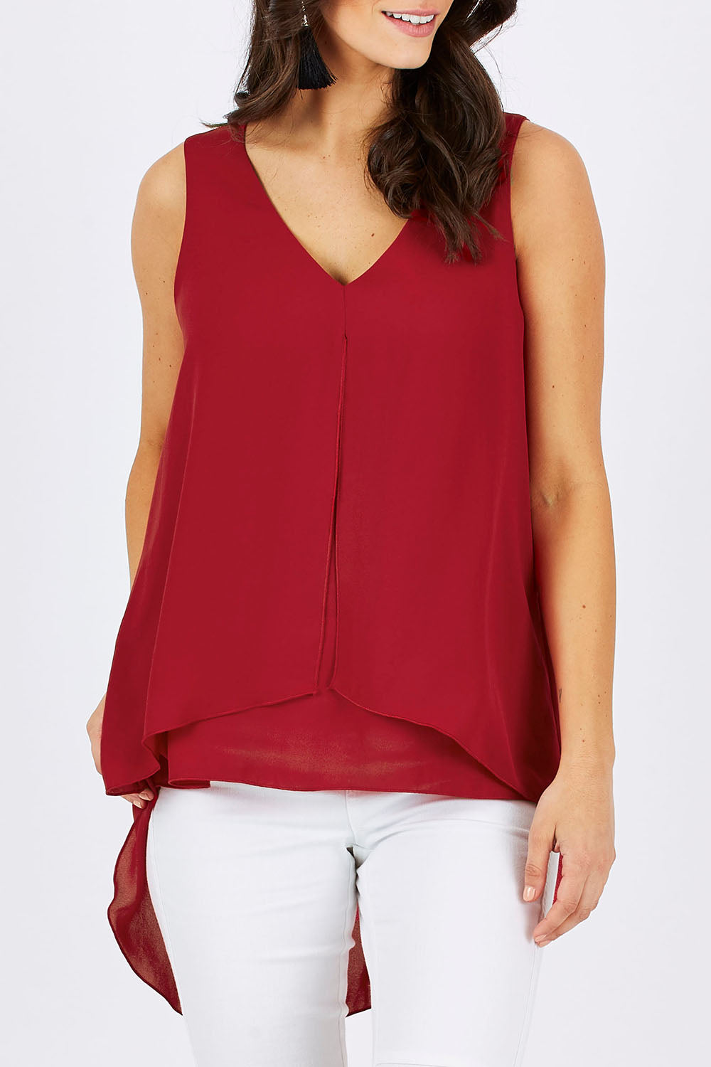 Model Georgia wearing size 10 of the Sugar Snaps Layers Tank in colour Red (Red), from the front, cropped image