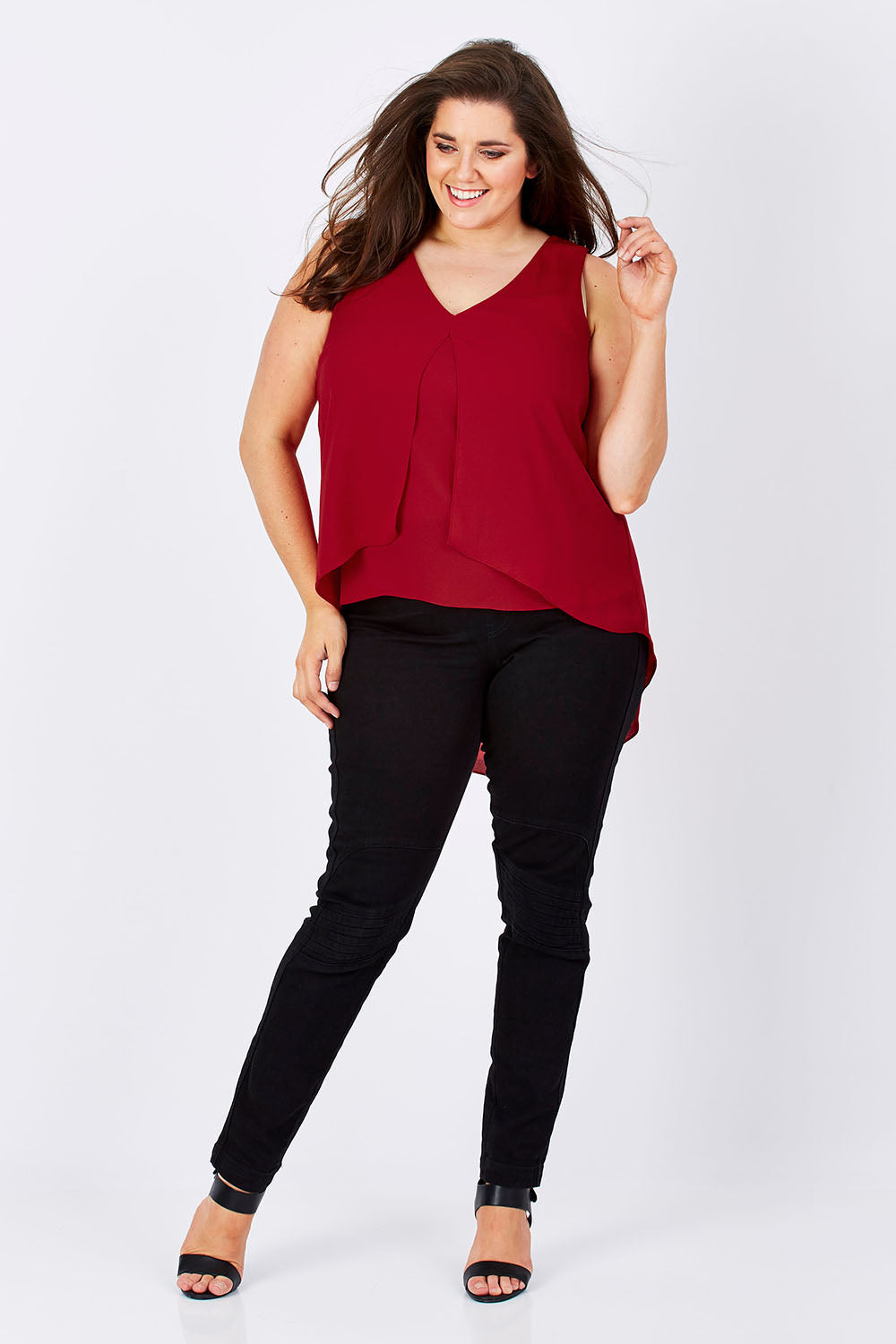 Model Mae wearing size 16 of the Sugar Snaps Layers Tank in colour Red (Red), from the front, showing the whole outfit