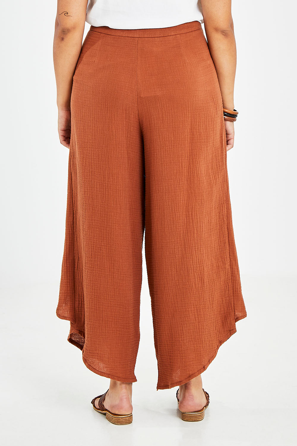 Model Sasha-Lee wearing size 16 of the Wrapped In You Cotton Pants in colour Cinnamon, from the back