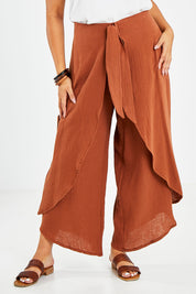 Model Sasha-Lee wearing size 16 of the Wrapped In You Cotton Pants in colour Cinnamon, from the front, cropped image
