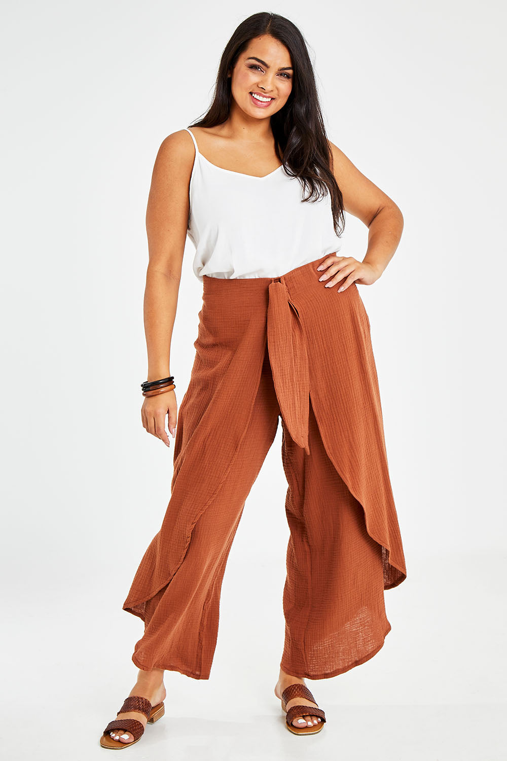 Model Sasha-Lee wearing size 16 of the Wrapped In You Cotton Pants in colour Cinnamon, from the front, showing the whole outfit