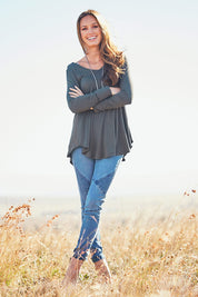 Model Emma wearing size 10 of the Long Sleeve Softly Swinging Bamboo Tee in colour Combat (Black), from the front, showing the whole outfit