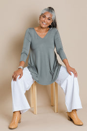 Model Nadine wearing size 10 of the Long Sleeve Softly Swinging Bamboo Tee in colour Fern (Green), from the front, showing the whole outfit
