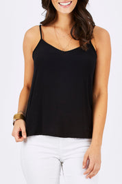 Model Georgia wearing size 10 of the Runaway Top in colour JetBlack (Black), from the front, cropped image