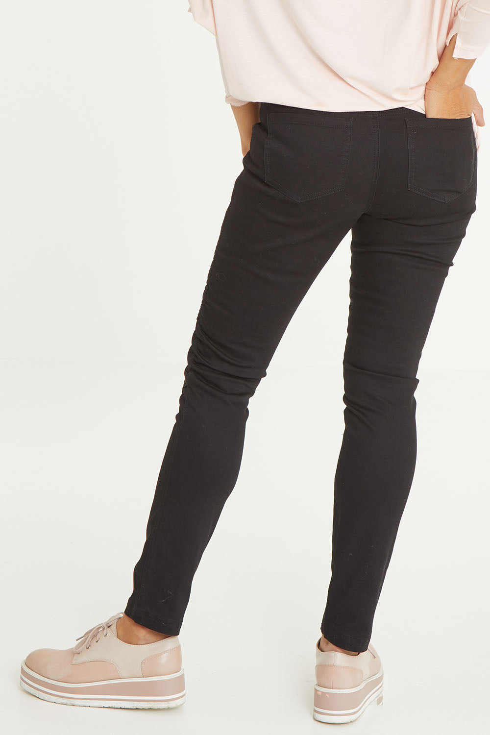 Model Cara wearing size 10 of the Wild Plains Stitched Jeggings in colour Black (Black), from the back