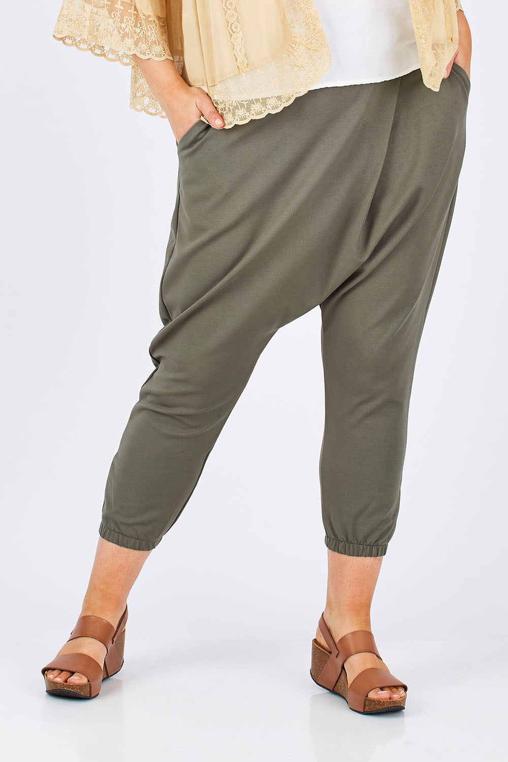 Model Jess wearing size 14 of the Relax With Me Pants in colour Moss (Green), from the front, cropped image