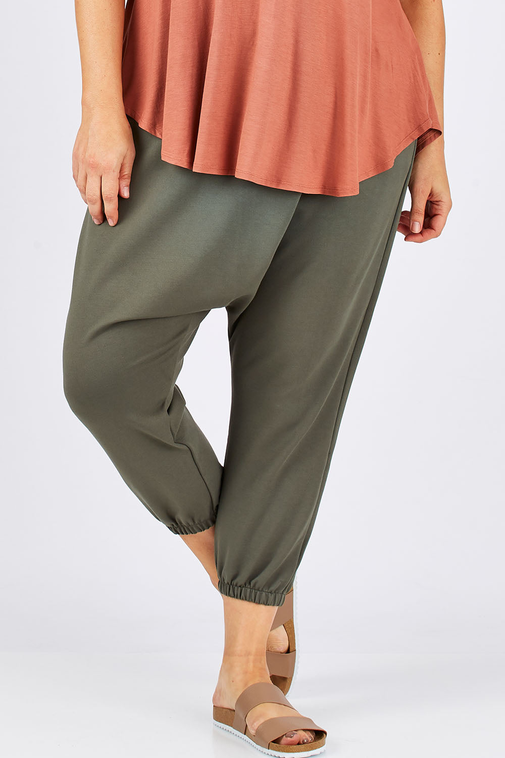 Model Ljubenka wearing size 18 of the Relax With Me Pants in colour Moss (Green), from the front, cropped image